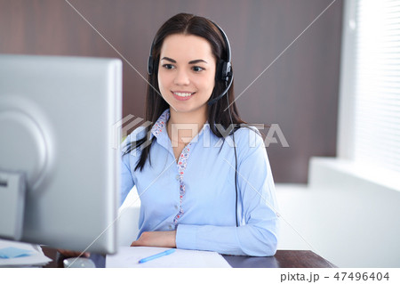 Young brunette business woman looks like a student girl working in office. Hispanic or latin Young brunette business woman looks like a student girl working in office. Hispanic or latin 47496404