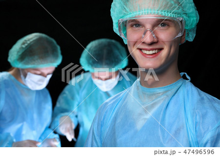Closeup of surgeons performing operation. Focus on male doctor. Medicine, surgery and emergency help 47496596
