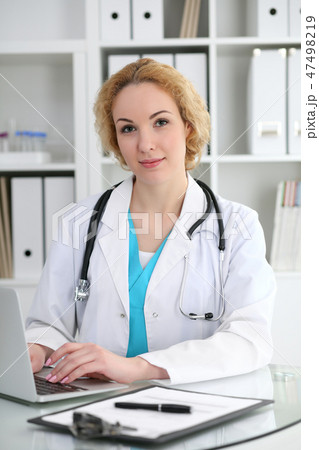 Doctor woman at work. Physician typing on laptop computer. Medicine, healthcare concept Doctor woman at work. Physician typing on laptop computer. Medicine, healthcare concept 47498219