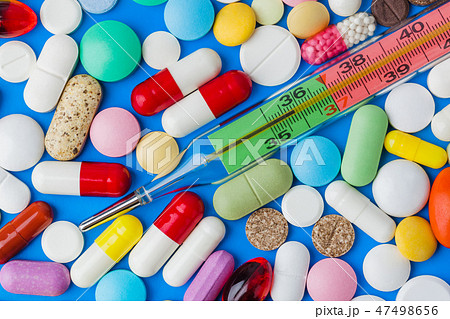 Pills and thermometer - medical background Pills and thermometer - medical background 47498656