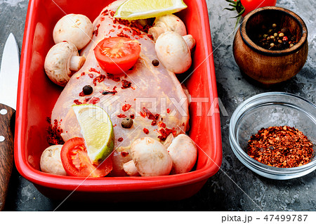 Raw chicken in baking dish Raw chicken in baking dish 47499787