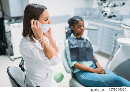 Female patient and dentist, stomatology cabinet Female patient and dentist, stomatology cabinet 47500392