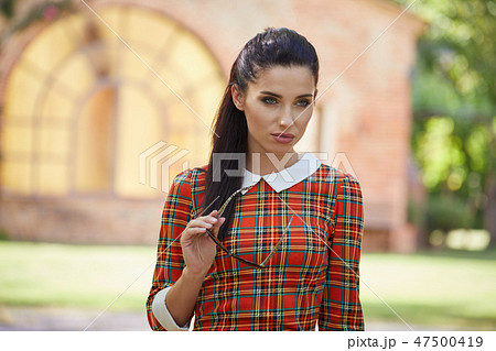 Smiling summer woman with sunglasses in italian garden 47500419