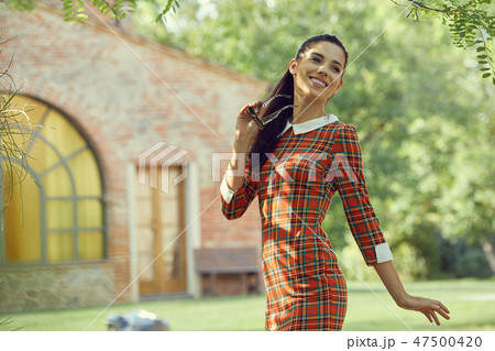 Smiling summer woman with sunglasses in italian garden 47500420