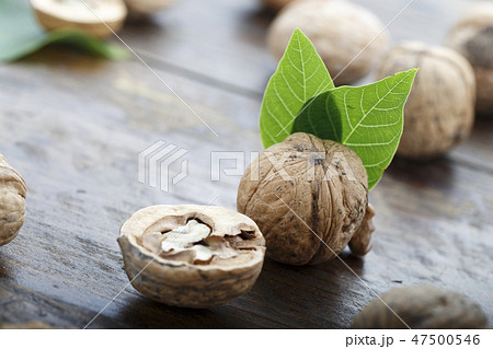 walnuts chopped on a wooden background 47500546