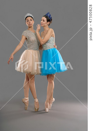 Two attractive ballerinas standing on socks and posing Two attractive ballerinas standing on socks and posing 47500828