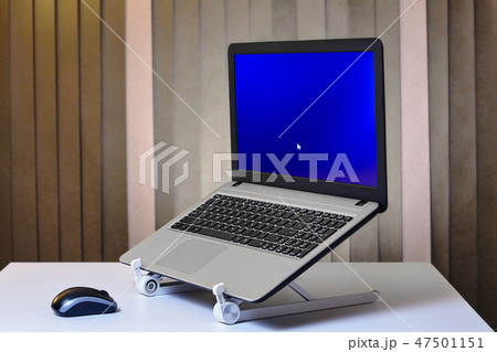 Laptop is started and installed on cooling stand. Laptop is started and installed on cooling stand. 47501151