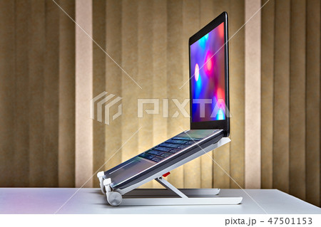 Standing laptop holder set up with notebook. 47501153