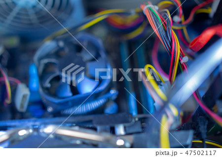 PC components in dust. Dusty power wires, CPU fan soft focus 47502117