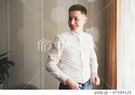 Young handsome man relaxing at his apartment in a hotel after business meeting 47504125