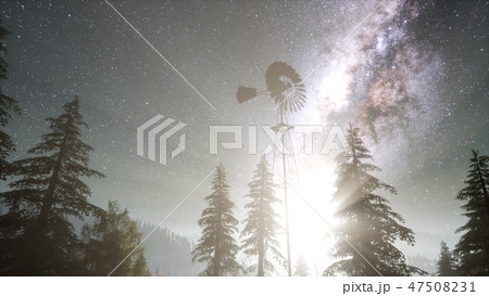 retro windmill in mountain forest with stars 47508231