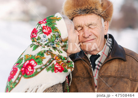 Portrait of happy senior couple. Elderly woman kiss her husband in weighty. old couple walkink in 47508464