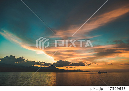 Colorful sunset sky over the Komodo island shore. Colorful sunset sky over the Komodo island shore. 47509653
