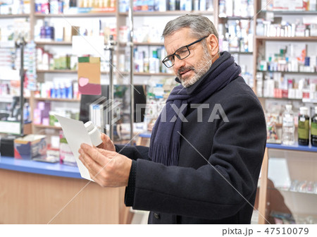 Mature man reading prescription in drugstore. 47510079