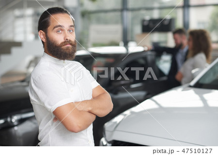 Handsome customer of car dealership posing. Handsome customer of car dealership posing. 47510127