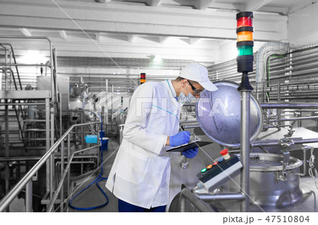technologist controls the production of dairy products At the plant 47510804