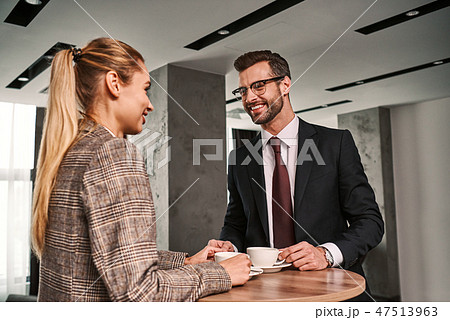 Man and woman drinking coffee at hotel hall. Business lunch Man and woman drinking coffee at hotel hall. Business lunch 47513963