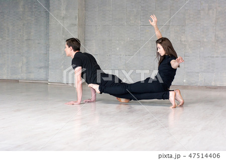 Young couple practices acrobatic balance. Young couple practices acrobatic balance. 47514406