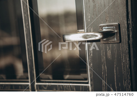 Modern style door handle on wooden door 47514760