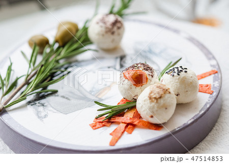 Labne cheese with green olives and spices close up 47514853