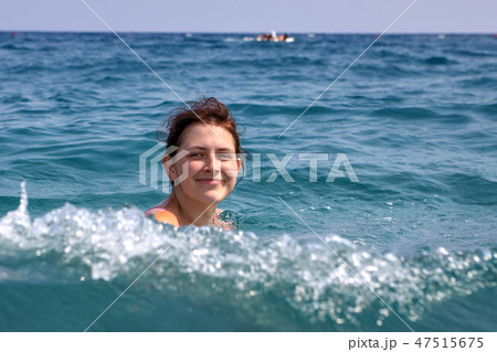 One Caucasian teen girl floundering in sea water. 47515675