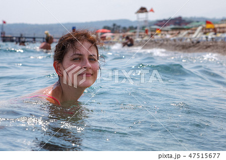 caucasian young woman bathing in sea near beach 47515677