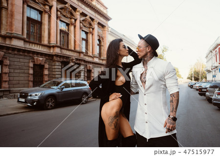 A young, sexy couple of lovers pose for a camera on the streets A young, sexy couple of lovers pose for a camera on the streets 47515977