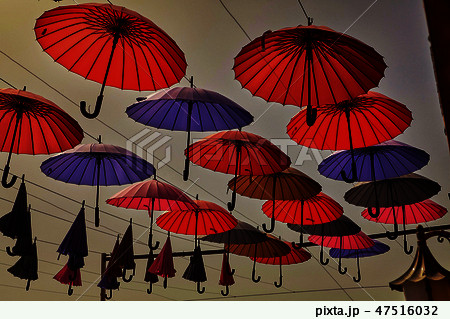 Colorful umbrellas hanging against the sky 47516032