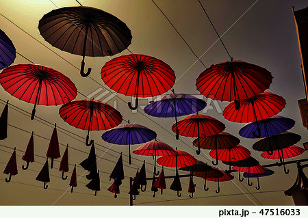 Multi Colored umbrellas hanging against sky  47516033