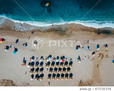 Beach with sun loungers on the coast of the ocean Beach with sun loungers on the coast of the ocean 47516356