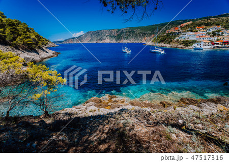 Amazing Greece, white sail boats in blue bay of picturesque colorful village Assos in Kefalonia Amazing Greece, white sail boats in blue bay of picturesque colorful village Assos in Kefalonia 47517316