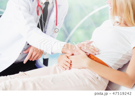 Male Doctor and Female Patient in Hospital Office 47519242