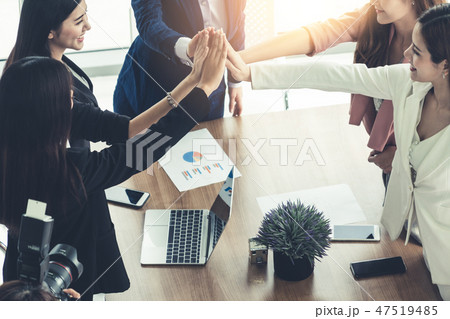Teamwork businesswomen joining hands in meeting. Teamwork businesswomen joining hands in meeting. 47519485
