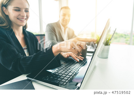 Businessman and businesswoman working in office. 47519502