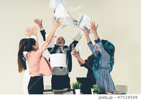 Business people throwing papers in the office. 47519589