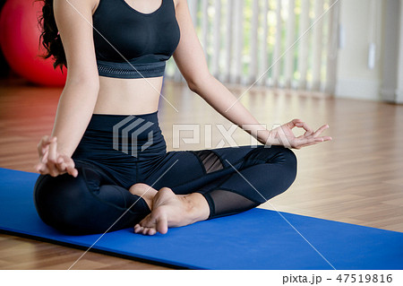 Young woman practice yoga in an gym studio. Young woman practice yoga in an gym studio. 47519816
