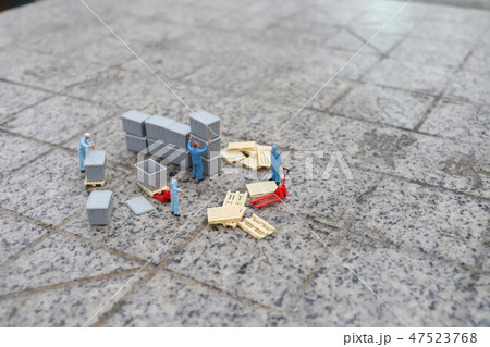 a mini worker figure using a trolley a mini worker figure using a trolley 47523768