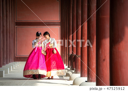 Korean lady in Hanbok or Korea gress and walk in an ancient town Korean lady in Hanbok or Korea gress and walk in an ancient town 47525912
