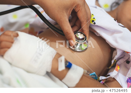 Doctor examining child and listen lung and heart 47526495