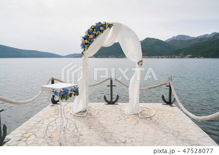 arch decorated with cloth and flowers for the wedding ceremony 47528077