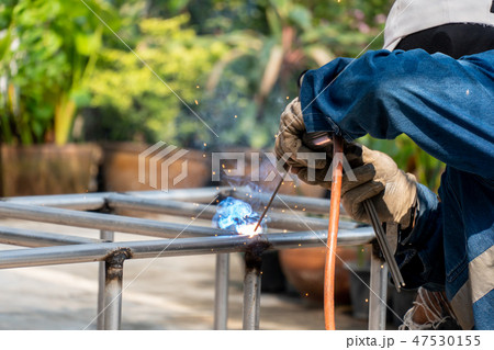 The welder is welding the steel frame. The welder is welding the steel frame. 47530155
