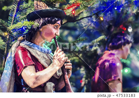 Wooden statue of a shepherd with a pipe. Wooden statue of a shepherd with a pipe. 47533183