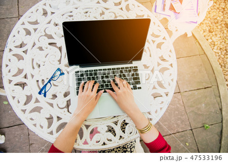 Top view of young working woman using laptop Top view of young working woman using laptop 47533196