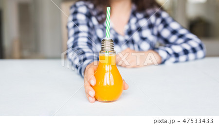 Drinks, diet and healthy lifestyle concept - woman giving you a bottle of natural juice 47533433