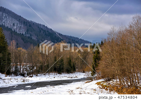 Beautiful winter landscape with a mountain river Beautiful winter landscape with a mountain river 47534804