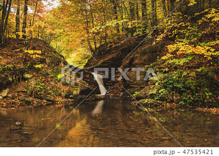 Autumn mountain waterfall 47535421