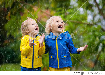 Kids play in autumn rain. Child on rainy day. Kids play in autumn rain. Child on rainy day. 47536525