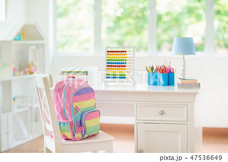 Kids bedroom with wooden desk and doll house. 47536649