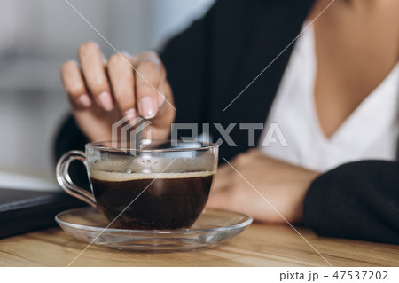 A wooden desktop with a morning black cup of coffee. 47537202