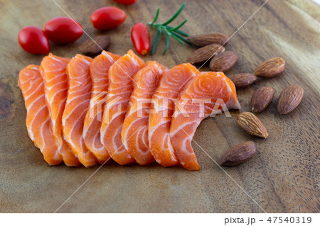 Salmon raw sashimi and Almonds with tomatoes  47540319